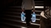 FILE - A man carries plastic jugs of water during a drought in Spain, Jan 31, 2024. Australian researchers say they have found a new way to remove salt from seawater using heat, which could help combat global water shortages.
