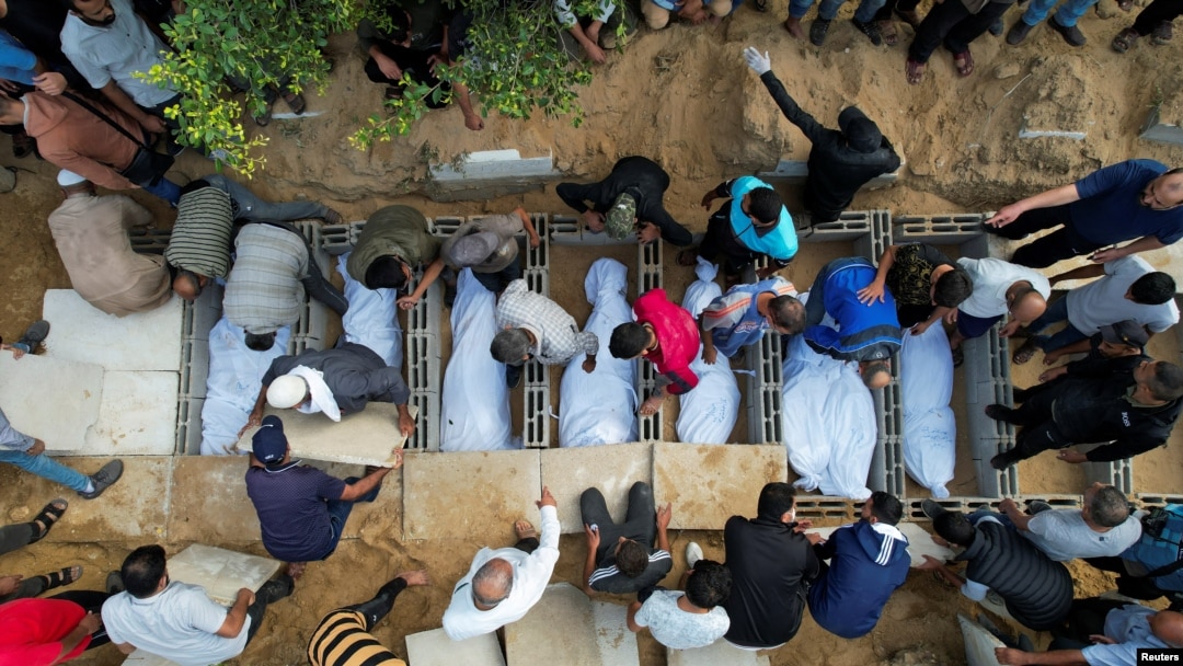 FILE - Para pelayat menguburkan jenazah warga Palestina dari keluarga Zraiee, yang tewas dalam serangan Israel, di sebuah pemakaman di Jalur Gaza tengah, 17 Oktober 2023. (REUTERS/Mohammed Fayq Abu Mostafa)