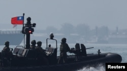 Members of Taiwan's Navy navigate onboard a special operation boat during a drill part of a demonstration for the media, to show combat readiness ahead of the Lunar New Year holidays, on the waters near a military base in Kaohsiung, Jan. 31, 2024.