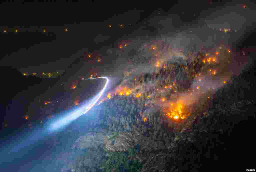 General view of a wildfire on the flank of a mountain in Bitsch near Brig, Switzerland.