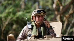 A Peruvian navy member rides in a light armored vehicle during a joint exercise between Japan and Peru at the Rim of the Pacific (RIMPAC) military exercises at Bellows Beach in Waimanalo, Hawaii, July 18, 2024.