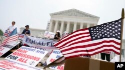 People protest outside of the Supreme Court in Washington, Thursday, June 29, 2023. 