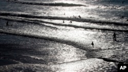 FILE - People swim in the Atlantic Ocean in Biarritz, southwestern France, Oct. 27, 2021. 