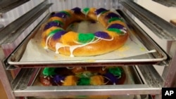 FILE - Traditional Mardi Gras king cakes by pastry chef Jean-Luc Albin at Maurice French Pastries are displayed on Feb. 10, 2011, in Metairie, La.