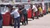 FILE - Auto rickshaw drivers line up to buy gas near a fuel station in Colombo, Sri Lanka, April 13, 2022. 