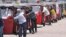 FILE - Auto rickshaw drivers line up to buy gas near a fuel station in Colombo, Sri Lanka, April 13, 2022. 