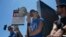 Justine Bateman, right, speaks outside Netflix during a Writers Guild rally as a strike by The Screen Actors Guild-American Federation of Television and Radio Artists is announced on July 13, 2023, in Los Angeles. 