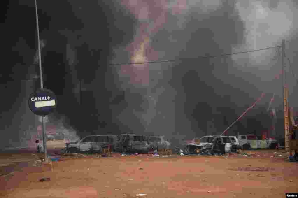 Supporters of the coup set fire to ruling party HQ while hundreds of them gather in front of the National Assembly in the capital Niamey, Niger.