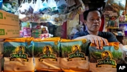 FILE - A vendor arrange packages of sugar at a market in Jakarta, Indonesia on Oct. 24, 2023.