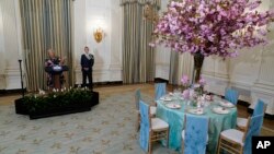 First lady Jill Biden, left, standing with White House Social Secretary Carlos Elizondo, speaks during a preview, April 24, 2023, for Wednesday's State Dinner with South Korea's President Yoon Suk Yeol at the White House in Washington.