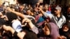 Palestinians queue as they wait to buy bread from a bakery, amid shortages of food supplies and fuel, as the conflict between Israel and Palestinian Islamist group Hamas continues, in Khan Younis in the southern Gaza, Nov. 17, 2023.