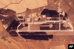 This satellite image released by Planet Labs PBC shows the aftermath of a Ukrainian drone attack on the Marinovka Air Base in Russia, Aug. 22, 2024.