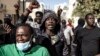 Protesters gesture after police fired tear gas at them outside the General Assembly in Dakar, Senegal, on Feb. 5, 2024.