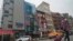 FILE - A six-story glass facade building, pictured second from left in New York's Chinatown, April 17, 2023, is believed to be the site of a foreign police outpost for China. On June 6, 2023, U.K. officials said China had closed similar stations across the nation. 