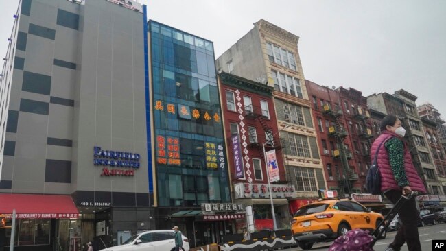 FILE — A six-story glass facade building, pictured second from left, in New York's Chinatown, April 17, 2023, is believed to be the site of a foreign police outpost for China.