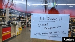 A sign notifies customers of a temporary closure due to IT issues at a Liquorland store in Canberra, Australia, July 19, 2024.