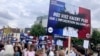 People rally against antisemitism, one carrying a placard reading 'Our lives worth more that an imported conflict' June 20, 2024, in Paris. 
