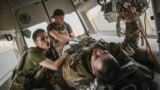 Ukrainian military paramedics evacuate a wounded serviceman from the front line near Bakhmut, March 23, 2023.