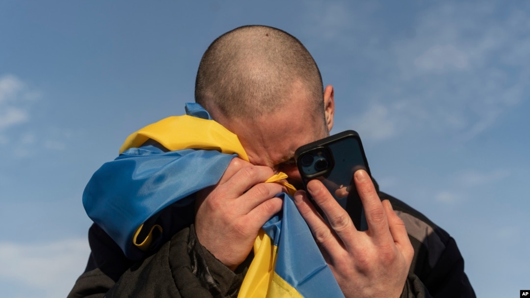 FILE - A recently swapped Ukrainian prisoner of war cries while calling his relatives after a prisoner exchange on the Ukraine-Russia border on Jan. 31, 2024. 