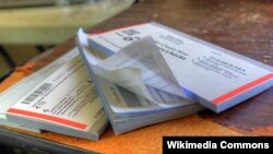 A stack of checkbooks. Many Native Americans lack access to banks and because of poor broadband access can't bank online.