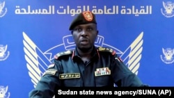 In this frame grab from a video posted by Sudan's state news agency, SUNA, on April 13, 2023, spokesman for the Sudanese Armed Forces Brig. Nabil Abdullah warns of conflict after the deployment of Sudan's paramilitary in the capital and other cities.