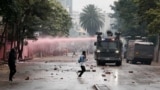 Riot police vehicles disperse protesters during an anti-government demonstration following nationwide deadly riots over tax hikes and a controversial now-withdrawn finance bill, in Nairobi, Kenya, July 16, 2024.