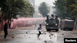 Riot police vehicles disperse protesters during an anti-government demonstration following nationwide deadly riots over tax hikes and a controversial now-withdrawn finance bill, in Nairobi, Kenya, July 16, 2024.