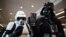 A cosplayer dressed as the Star Wars character Darth Vader (R) holds a mobile phone displaying the Government alert issued to all smartphones to test life-threatening emergencies, at the Scarborough Sci-Fi Convention in Scarborough, north-east England, April 23, 2023.