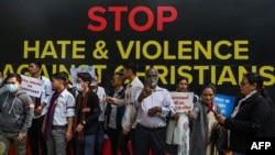 FILE - Activists and members representing the Christian community take part in a protest against what they claim as an increase in hostility, hate, and violence against Christians in various parts of India, in New Delhi, Feb. 19, 2023.
