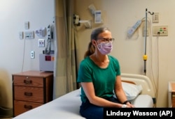 Kathleen Jade is waiting to receive her third dose of a cancer vaccine at the University of Washington, Tuesday, May 30, 2023, in Seattle. (AP Photo/Lindsey Wasson)