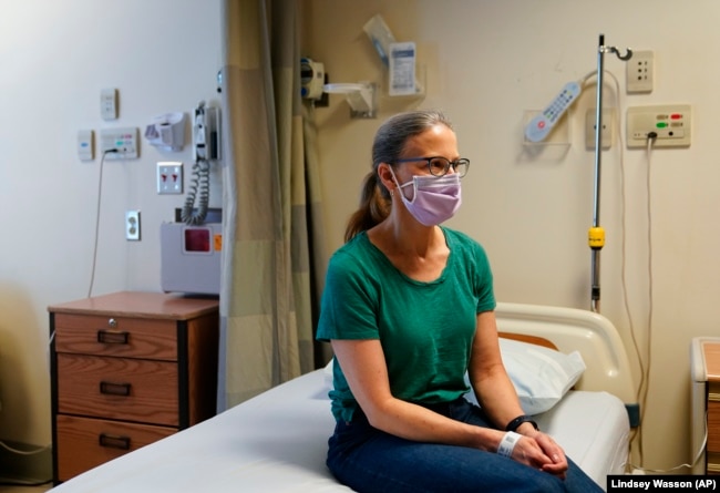 Kathleen Jade is waiting to receive her third dose of a cancer vaccine at the University of Washington, Tuesday, May 30, 2023, in Seattle. (AP Photo/Lindsey Wasson)