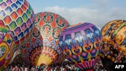 Participants prepare to fly hot air balloons during the traditional hot air balloon festival in Wonosobo, Central Java, Indonesia, during the Eid al-Fitr holiday celebrating the end of the Muslim holy fasting month of Ramadan.