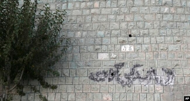 A graffiti which reads in Farsi: "Woman Life Freedom" the key slogan of anti-government protests after the death of Mahsa Amini in September 2022, is written on the wall of a park in Tehran, Iran, Sept. 11, 2023.