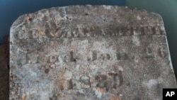 A tombstone bearing the name of Caezer Smith and dated 1839 is displayed on the site of a recently rediscovered African burial ground in Kingston, NY, Aug. 5, 2024.