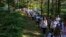 People march in memory of the 1995 Srebrenica massacre, in Nezuk, Bosnia, July 8, 2023. 