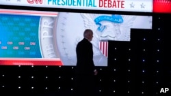 US President Joe Biden walks from the stage during a break in a presidential debate with Republican presidential candidate former President Donald Trump, June 27, 2024, in Atlanta.