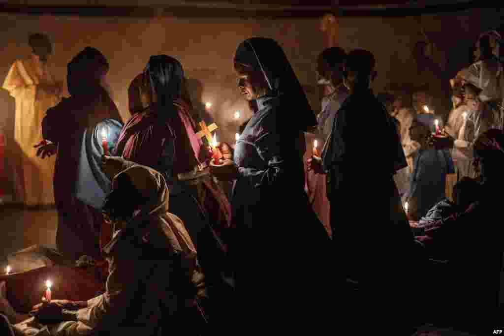 Worshippers of the Legio Maria African Church Mission gather to pray during the Christmas Eve vigil mass in a church near Ugunja, on December 24, 2023.