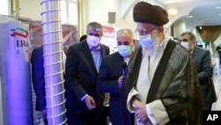 FILE - Supreme Leader Ayatollah Ali Khamenei, right, visits an exhibition of the country's nuclear achievements, at his office compound in Tehran, Iran, June 11, 2023, in this photo released by the office of the Iranian supreme leader. 