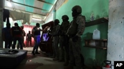FILE - Police and soldiers conduct a joint operation searching for drugs and weapons in a neighborhood of Duran, Ecuador, Feb. 1, 2024. On Jan. 8, President Daniel Noboa declared a national state of emergency due to a wave in crime.