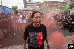 A supporter of the Move Forward party shouts during a protest outside Thailand's Parliament in Bangkok, Wednesday, July 19, 2023.