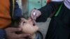 FILE - A health worker administers a polio vaccine to a child in Peshawar, Pakistan, March 4, 2024. 