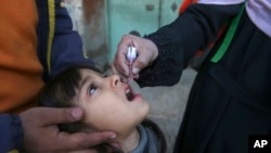 FILE - A health worker administers a polio vaccine to a child in Peshawar, Pakistan, March 4, 2024. 