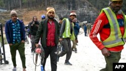 Rescue personnel arrive for manual drilling at a collapsed under-construction road tunnel Uttarkashi, state of Uttarakhand, in northern India, Nov. 27, 2023. The collapse on Nov. 12 trapped 41 workers inside.