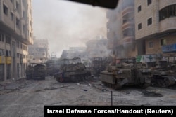 Israeli military vehicles maneuver during the ongoing ground operation of the Israeli army against Palestinian Islamist group Hamas, in the Gaza Strip, Nov. 13, 2023.