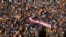 Tens of thousands of people rally around a banner that says "PSOE sells Spain" during a protest against an amnesty bill for those involved with Catalonia's failed 2017 independence bid, in Madrid, Nov. 18, 2023. 