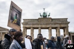 FILE - Demonstrators against dictatorship and against human rights violations in Senegal protest at the Brandenburg Gaten in Berlin, Germany on February 10, 2024.