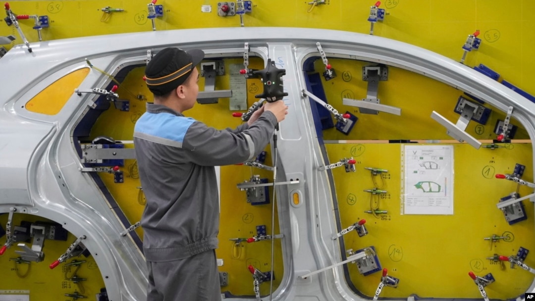 A worker examines a car frame at a Vinfast factory in Hai Phong, Vietnam on Sept. 29, 2023.