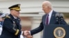 President Joe Biden shakes hands with outgoing Joint Chiefs Chairman Gen. Mark Milley, during an Armed Forces Farewell Tribute in honor of Milley at Joint Base Myer-Henderson Hall, Sept. 29, 2023, in Fort Myer, Va.