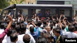 FILE PHOTO: A police van transports some of those convicted in connection with a riot in Gujarat in 2002, outside a court after a ruling in Ahmedabad, India June 2, 2016. 