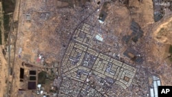 This satellite image provided by Maxar Technologies shows an overview of tents, shelters and people in Rafah, Gaza, Feb. 7, 2024. (Maxar Technologies via AP)